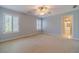 A spacious bedroom with two shuttered windows, light-blue walls, neutral carpet, and a ceiling fan at 980 Windsor Place Cir, Grayson, GA 30017