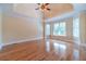 Spacious bedroom featuring hardwood floors, a tray ceiling, and lots of natural light at 980 Windsor Place Cir, Grayson, GA 30017