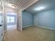 Bonus room with neutral carpet and paint with views into the adjacent carpeted room at 980 Windsor Place Cir, Grayson, GA 30017