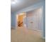 Upstairs bonus room with neutral carpet, paint, and many doorways at 980 Windsor Place Cir, Grayson, GA 30017