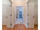 Hallway with marble floors leads to a bathroom and has multiple closets at 980 Windsor Place Cir, Grayson, GA 30017