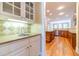 Butler's pantry with sink and cabinets, opening to the main kitchen at 980 Windsor Place Cir, Grayson, GA 30017