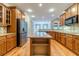 Spacious kitchen features an island, stainless appliances, and hardwood floors at 980 Windsor Place Cir, Grayson, GA 30017