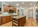 Well-equipped kitchen features an island, custom cabinets, and hardwood floors at 980 Windsor Place Cir, Grayson, GA 30017