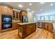 Kitchen featuring wooden cabinetry, an island, stainless steel appliances, and hardwood floors at 980 Windsor Place Cir, Grayson, GA 30017