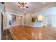 Open living room with hardwood floors, fireplace, and access to the kitchen and staircase at 980 Windsor Place Cir, Grayson, GA 30017