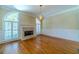 Living room with hardwood floors, fireplace, large arched windows, and natural light at 980 Windsor Place Cir, Grayson, GA 30017
