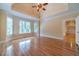 The main bedroom features hardwood floors, a tray ceiling, large windows, and neutral wall colors at 980 Windsor Place Cir, Grayson, GA 30017