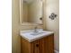 Elegant powder room with wood vanity, white countertop, modern faucet, and framed mirror at 980 Windsor Place Cir, Grayson, GA 30017