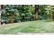 Grassy backyard with a mature tree line is perfect for enjoying nature at 1477 Triple Creek Nw Ct, Kennesaw, GA 30144