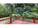 Lovely view of the backyard from the wooden deck, featuring mature trees at 1477 Triple Creek Nw Ct, Kennesaw, GA 30144