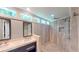 Bathroom boasts double vanity and a walk-in shower with natural pebble accents at 1477 Triple Creek Nw Ct, Kennesaw, GA 30144