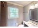 Charming bathroom with a window over the toilet and granite vanity at 1477 Triple Creek Nw Ct, Kennesaw, GA 30144
