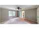 Large bedroom featuring plush carpeting, ceiling fan, and ensuite bathroom at 1477 Triple Creek Nw Ct, Kennesaw, GA 30144