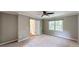 Bright bedroom with plush carpeting, ceiling fan, and large window at 1477 Triple Creek Nw Ct, Kennesaw, GA 30144