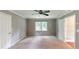 Carpeted bedroom with a ceiling fan, a window, and neutral colored walls at 1477 Triple Creek Nw Ct, Kennesaw, GA 30144