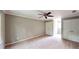 Large bedroom with neutral carpeting, ceiling fan, and modern trim at 1477 Triple Creek Nw Ct, Kennesaw, GA 30144