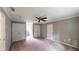 Bright bedroom with ceiling fan and double door closet and doorway to hallway at 1477 Triple Creek Nw Ct, Kennesaw, GA 30144