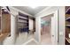 Walk-in closet leads to modern bathroom with double vanity at 1477 Triple Creek Nw Ct, Kennesaw, GA 30144