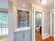 Hallway featuring a wet bar and access to the powder room at 1477 Triple Creek Nw Ct, Kennesaw, GA 30144