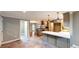 Open concept kitchen with modern gray cabinets, white countertop island, and stainless appliances at 1477 Triple Creek Nw Ct, Kennesaw, GA 30144