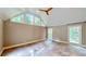 Living room with high vaulted ceilings, large windows, and tile flooring at 1477 Triple Creek Nw Ct, Kennesaw, GA 30144