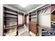 A spacious walk-in closet with custom shelving and storage solutions at 1477 Triple Creek Nw Ct, Kennesaw, GA 30144