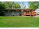 A serene backyard features a lush green lawn, wood deck, and mature trees at 3372 Ward Drive Southwest Sw Dr, Atlanta, GA 30354