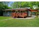 A serene backyard features a lush green lawn, wood deck, and pergola at 3372 Ward Drive Southwest Sw Dr, Atlanta, GA 30354