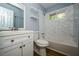A modern bathroom featuring tiled walls, tub, white vanity and shelves at 3372 Ward Drive Southwest Sw Dr, Atlanta, GA 30354