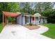 Beautiful front exterior view with a carport, walkway and well-manicured lawn at 3372 Ward Drive Southwest Sw Dr, Atlanta, GA 30354