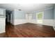Open living room with hardwood floors, wainscoting and large windows at 3372 Ward Drive Southwest Sw Dr, Atlanta, GA 30354