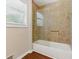 The bathroom is updated with a glass shower door, white tub, and stylish, neutral-toned tile at 3544 Chestatee Dr, Marietta, GA 30062