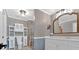 Bright bathroom showcases a glass shower, white cabinets, a large mirror, and modern vanity at 3544 Chestatee Dr, Marietta, GA 30062