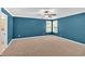 Spacious carpeted bedroom with natural light from two windows and a ceiling fan at 3544 Chestatee Dr, Marietta, GA 30062