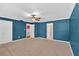 Carpeted bedroom with blue walls, white trim, and a ceiling fan at 3544 Chestatee Dr, Marietta, GA 30062