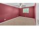Red bedroom with plush carpet, a ceiling fan, and window providing ample light at 3544 Chestatee Dr, Marietta, GA 30062