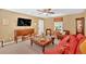 This living room is furnished with a mix of wood furniture, bright red accents, and a ceiling fan at 3544 Chestatee Dr, Marietta, GA 30062