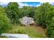 Aerial view of the rear of the home with deck and walk out basement with lush lawn at 3642 Fowler Rdg, Douglasville, GA 30135