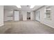 Finished basement with carpeted floor, built-in sink and exit doors and ample lighting at 3642 Fowler Rdg, Douglasville, GA 30135