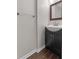 Modern bathroom featuring a dark vanity with a white sink and a framed mirror at 3642 Fowler Rdg, Douglasville, GA 30135