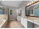 Bright bathroom featuring double sinks, a soaking tub, and a separate glass-enclosed shower at 3642 Fowler Rdg, Douglasville, GA 30135