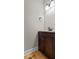 Powder room with dark wood vanity and ample lighting and wooden floor at 3642 Fowler Rdg, Douglasville, GA 30135