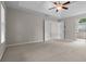Spacious empty bedroom featuring a tray ceiling, and neutral colored carpet at 3642 Fowler Rdg, Douglasville, GA 30135