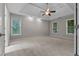 Spacious bedroom featuring a tray ceiling, three large windows, and neutral walls at 3642 Fowler Rdg, Douglasville, GA 30135