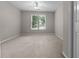 Cozy carpeted bedroom with a ceiling fan and natural light streaming through the window at 3642 Fowler Rdg, Douglasville, GA 30135