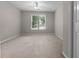 Carpeted bedroom with window offering natural light and tree views at 3642 Fowler Rdg, Douglasville, GA 30135