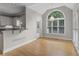 Bright dining area featuring a large arched window and hardwood floors at 3642 Fowler Rdg, Douglasville, GA 30135