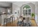 Bright dining area featuring a large arched window, hardwood floors, and an elegant chandelier at 3642 Fowler Rdg, Douglasville, GA 30135
