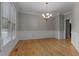 This is a nice dining room space featuring hardwood floors, crown molding, and an elegant chandelier at 3642 Fowler Rdg, Douglasville, GA 30135